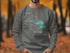 Grey sweatshirt with "Beautiful Pinhola Lake South Dakota" graphic.