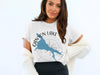 White t-shirt with blue Canyon Lake map, Arizona text, and compass design.