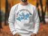 White sweatshirt with blue Lake Minnetonka map design and compass graphic.