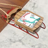 Wooden and red sled ornament with "Merry Christmas From Wallaby Lake" inscription.