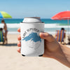 White can cooler with Lake Superior map and compass design held at the beach.
