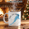 White mug with "Lake Las Vegas Nevada" and compass design, steaming.