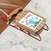 Wooden sled ornament with "Merry Christmas From Lake Pleasant" text and snowflakes.