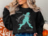 Black sweatshirt featuring a teal map of Missouri with "Beautiful Lakewood Lakes" text.