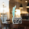 Champlain Life sticker with aqua lake outline on glass
