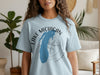 Light blue t-shirt with a blue outline of Indiana and a compass graphic.
