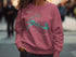 Pink sweatshirt with a map and compass graphic of Flagstaff Lake, Maine.