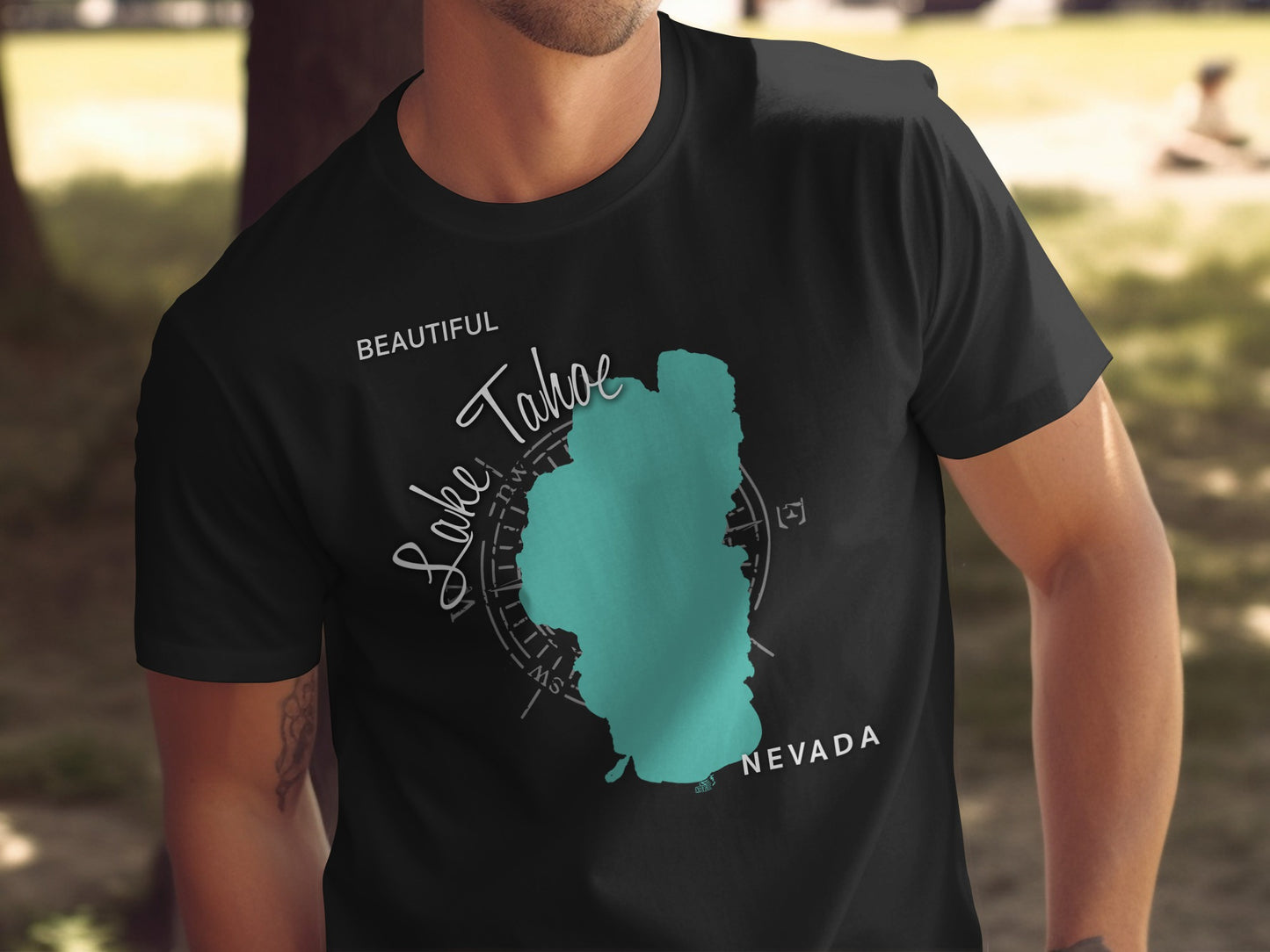 Black t-shirt with teal Lake Tahoe outline and compass rose graphic.