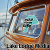 Turquoise sticker on boat window reads "Pend Oreille Life". "Lake Lodge Media" text below.