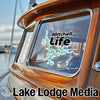 Sticker with "Mitchell Life" and lake shape on a boat window, "Lake Lodge Media" text below.