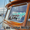 Turquoise Spivey Life sticker on a wooden boat window with Lake Lodge Media text.