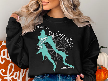 Black crewneck sweatshirt with a teal map outline and compass rose.