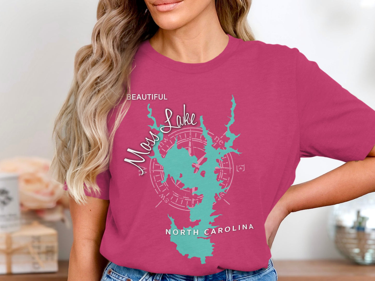 Pink t-shirt with a turquoise lake outline and compass rose graphic.