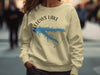 Light yellow sweatshirt with blue Fellows Lake graphic and compass design.
