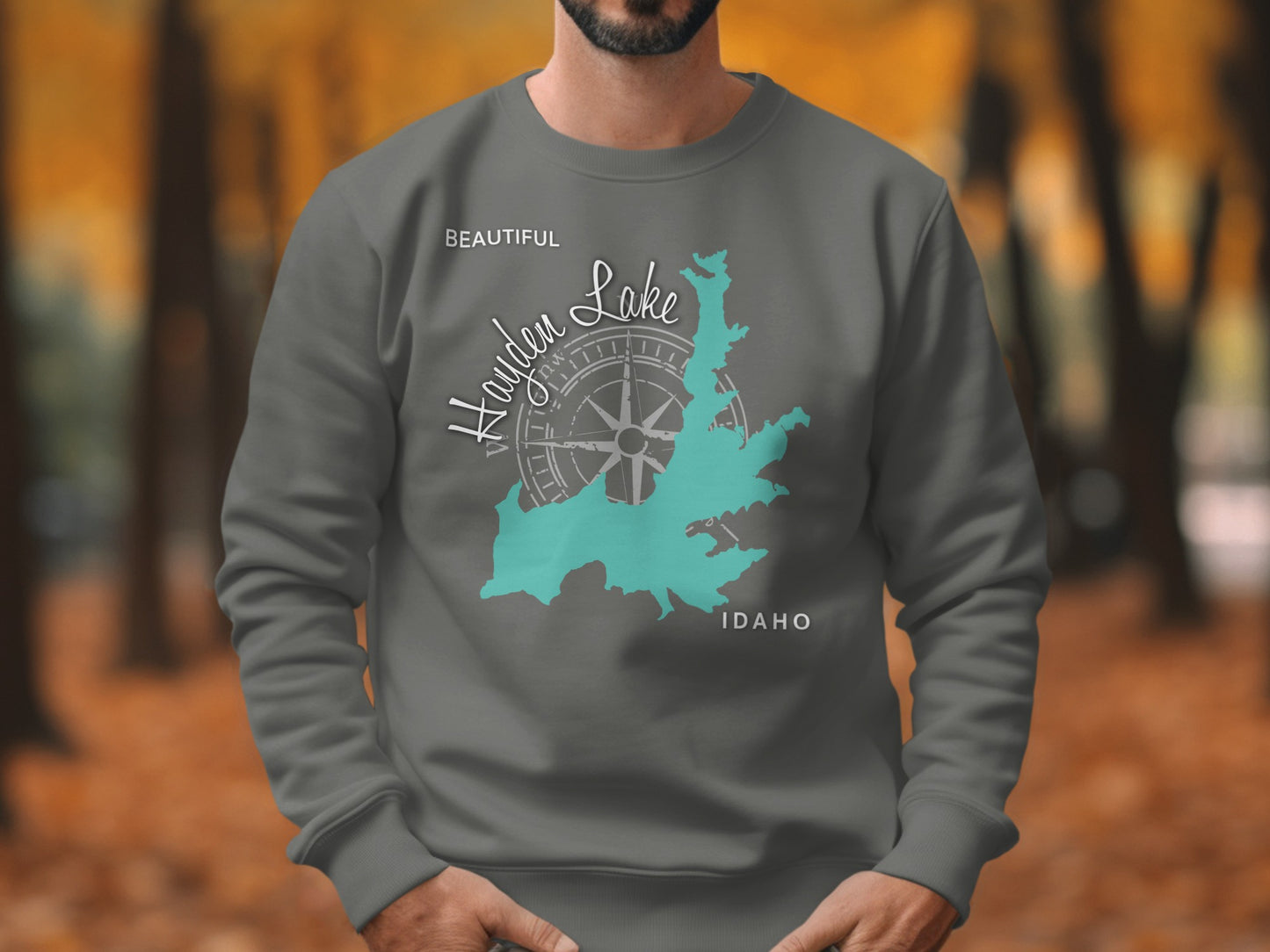 Grey sweatshirt with teal map of Hayden Lake, Idaho and compass design.