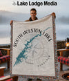 Throw blanket with a teal map of South Holston Lake and compass rose design.