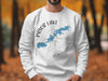 White sweatshirt with "Prior Lake Minnesota" text and blue lake outline over compass.