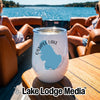 A white insulated wine tumbler with an Ossipee Lake New Hampshire map graphic sits on a boat table.