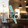 Owasco Life sticker on glass with teal lake outline.