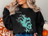 Black sweatshirt featuring "Lake Tapps Washington" and a turquoise map design.