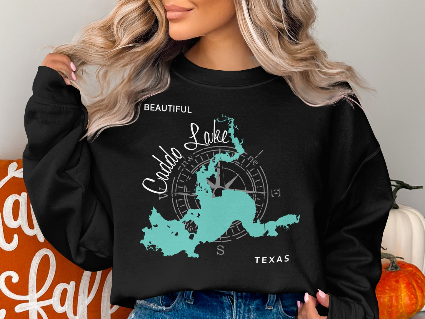 Black sweatshirt with a teal map of Caddo Lake, Texas, and compass graphic.