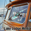 Sticker with text "Holston Life" and map graphic on a wooden boat window.