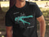 Black t-shirt with a teal map of Fellows Lake and compass graphic.