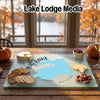Glass cutting board featuring a map of Big Lake, Arizona, arranged on a rustic wooden table with cheese, crackers, and snacks.