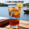 Iced tea glass with Enada Lake map design and compass, outdoors setting.