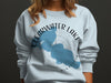 Light blue sweatshirt with Clearwater Lake Minnesota map and compass design.