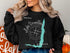 Black sweatshirt with "Beautiful Lake Vermilion Minnesota" and compass graphic.