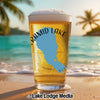 Glass of beer with Pyramid Lake, Nevada outline and text on beach background.