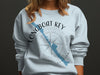 Light blue sweatshirt with "Longboat Key Florida" text, map, and compass rose graphic.