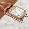 Red sled ornament with wooden top printed "Merry Christmas from Cave Run Lake".