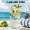 Kabetogama lake glass with lime and mint on beach with sailboat