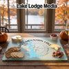 A custom tempered glass cutting board featuring an Eagle Mountain Lake map design, displayed on a wooden table with snacks.