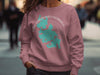 Pink sweatshirt with Lake Chaubunagungamaug Massachusetts map and compass design.