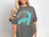 Augur Lake New York graphic on a dark grey t-shirt with compass and lake outline.