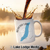White mug with Redfish Lake, Idaho design and compass, with coffee pouring in.