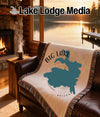 Throw blanket with a teal map of Big Lake, Arizona on a couch.