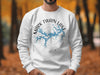 White crewneck sweatshirt with Mark Twain Lake, Missouri map and compass design.