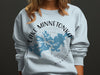 Long-sleeved light blue sweatshirt with Lake Minnetonka Minnesota map and compass graphic.
