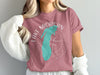 Pink t-shirt with teal Michigan outline and compass design.