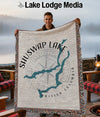 Man holding a Shuswap Lake, British Columbia map blanket with compass rose.