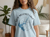 Light blue t-shirt with "New Melones Lake California" text and compass graphic.