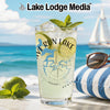 Glass with beverage, lime slices, mint, and compass map design.
