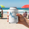 White can cooler with blue Percy Priest Lake map and compass on a beach.