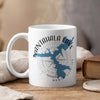 White mug with Nantahala Lake map and compass design, steaming.