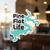 Sticker with black text "Pine Flat Life" and teal lake outlines.