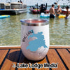 A white insulated wine tumbler with a Big Lake Arizona graphic sits on a wooden boat deck.
